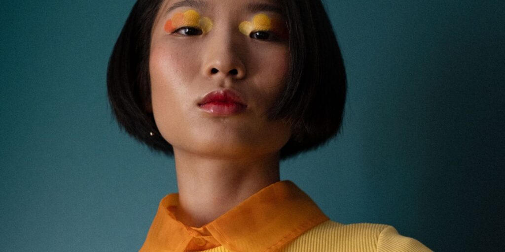 Asian woman wearing yellow and orange eyeshadow