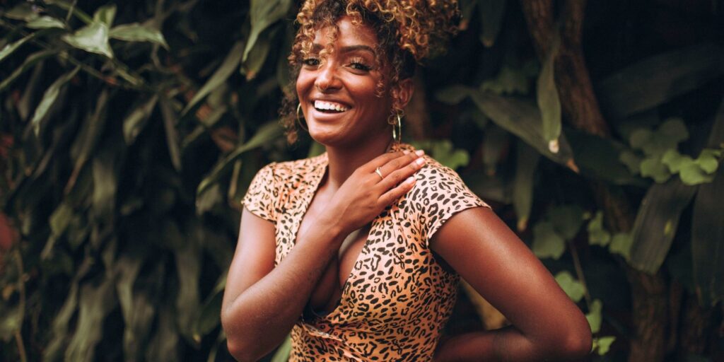 Beautiful woman with curly hair and a big smile