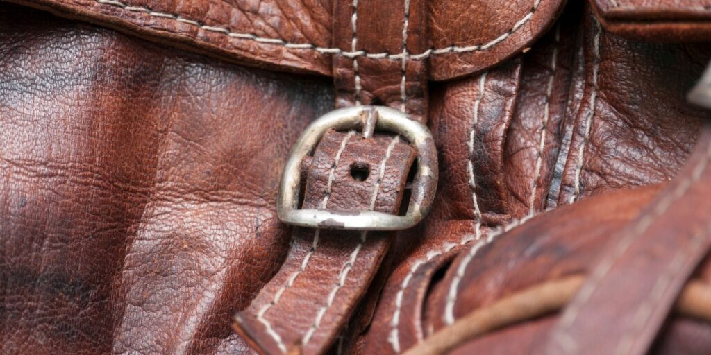 Close up of a used leather backpack and it's buckle