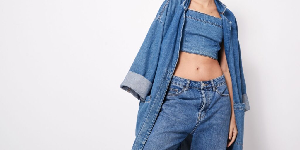 Woman wearing denim on denim. Jean shorts, jean top and denim jacket