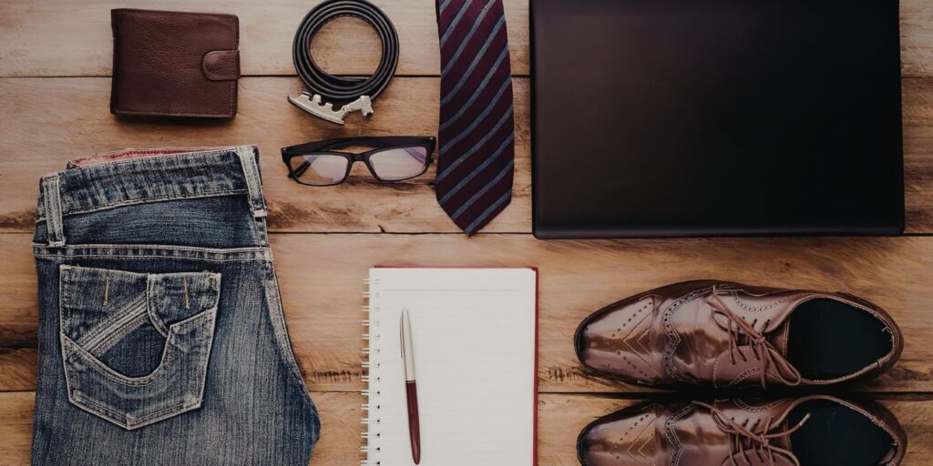 Items spread out on wood of business casual themed attire