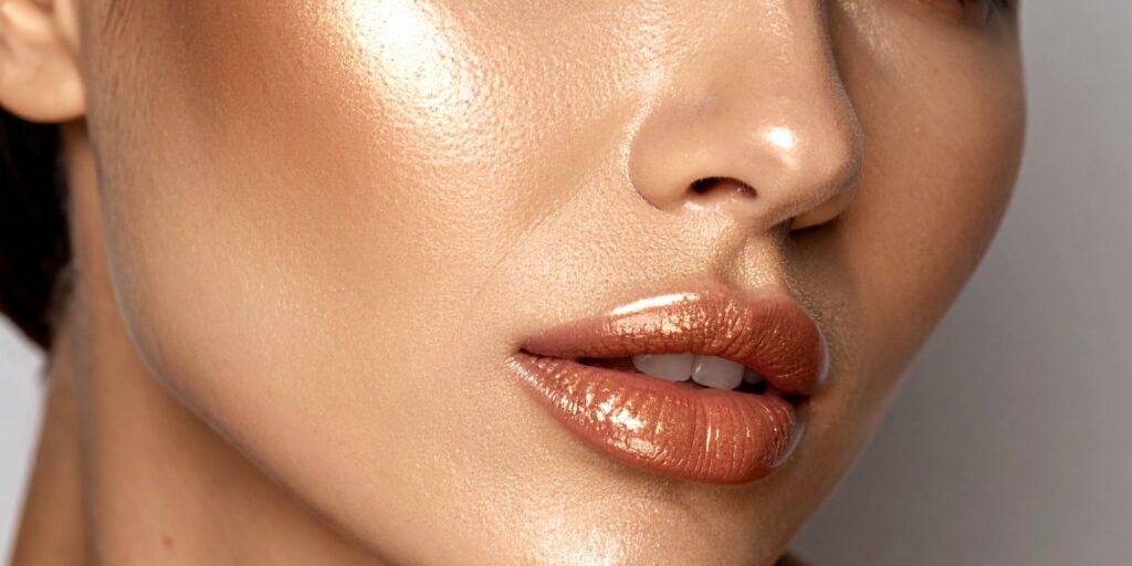 close up of a woman's face that has bronzer and highlighter makeup