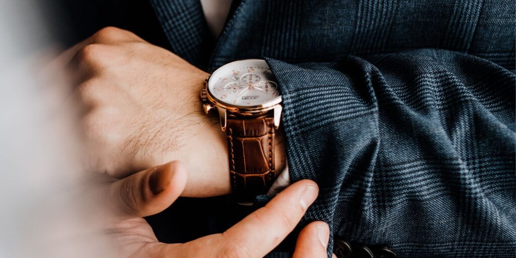 Close-up of a man's wrist wearing a brown leather strap watch