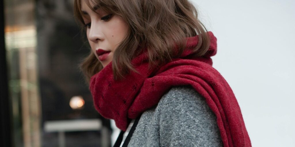 A beautiful Asian woman wearing a red scarf in winter