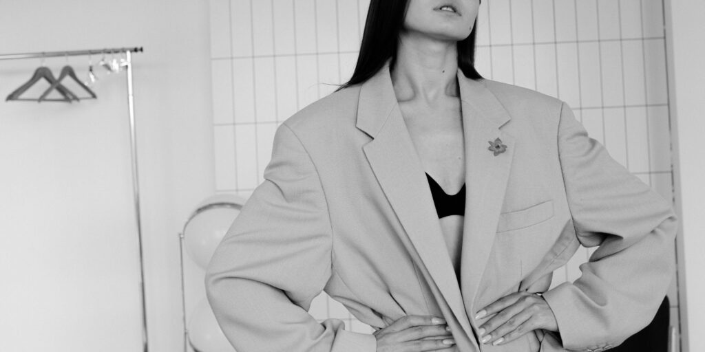 Black and white image of a woman wearing an oversized blazer