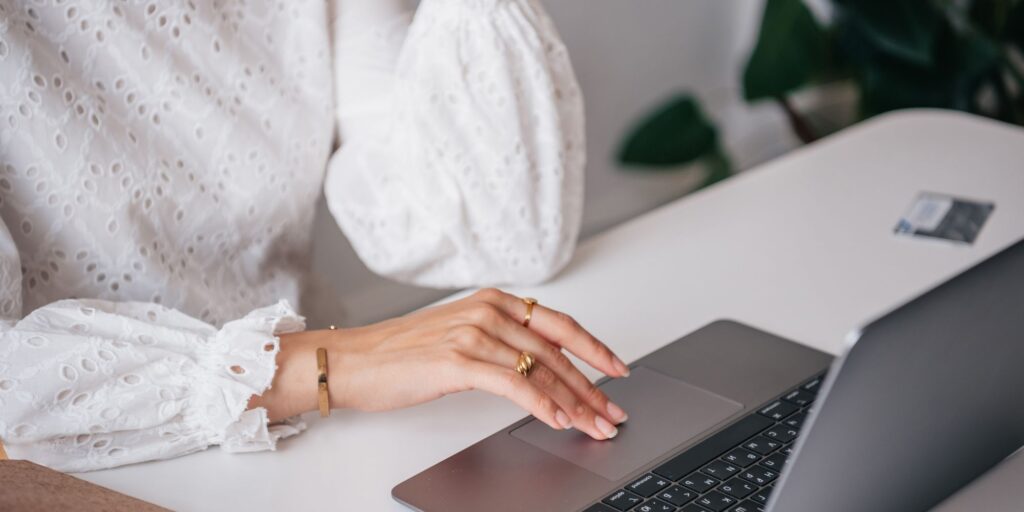A woman is signing up for the online shopping platform Vinted, using her Mabook