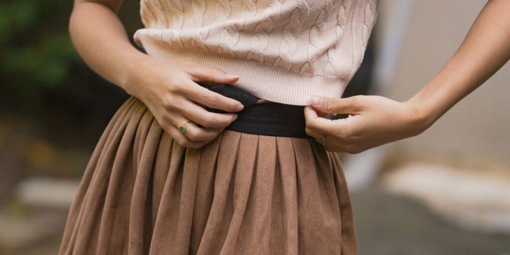 waist with a black belt and tonal colored clothes