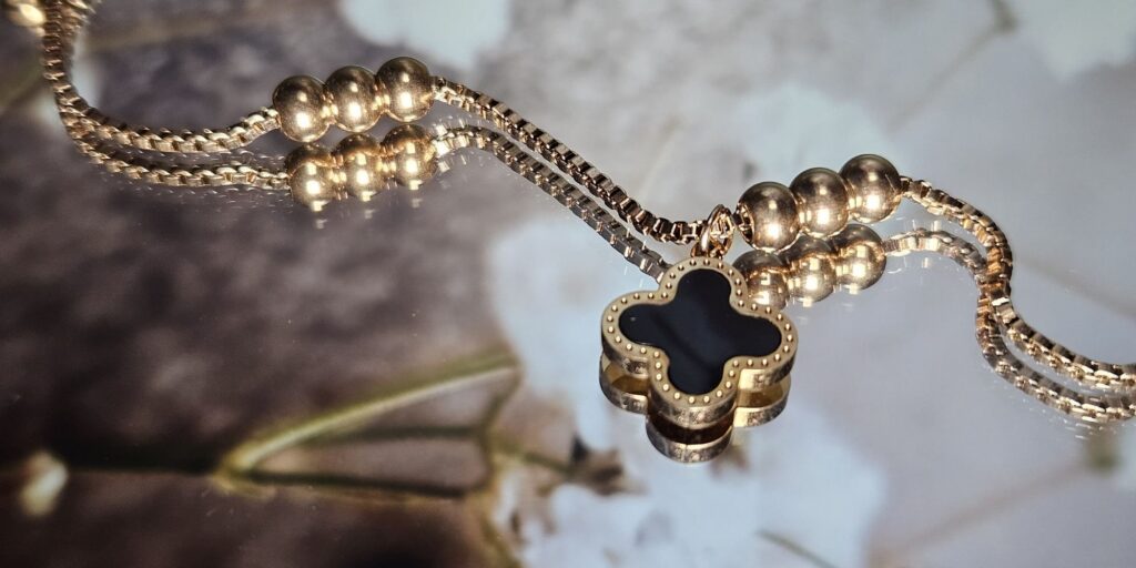 Black Van cleef with gold chain