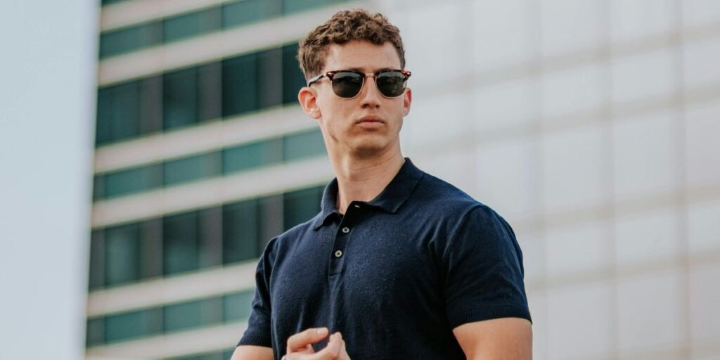 A man wearing sunglasses and a polo top