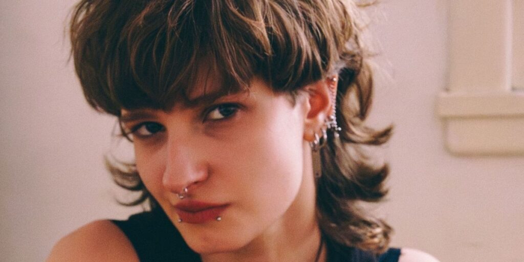 Edgy woman with a wolf cut and nose ring